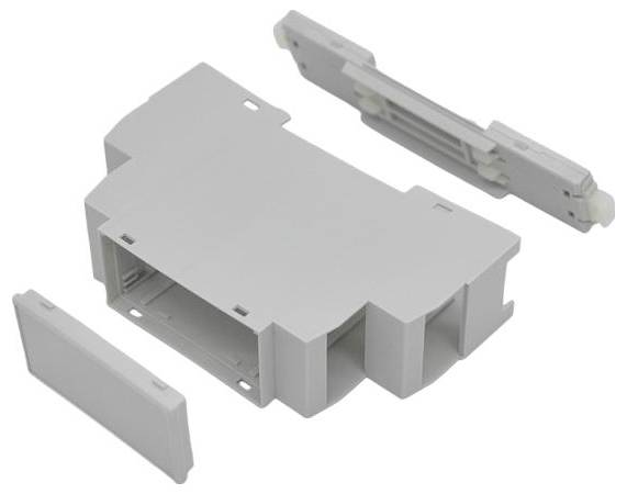 Tři šedé plastové součásti elektrického konektoru jsou zobrazeny: centrální pouzdro se dvěma bočními kryty a horní zatvarovací prvek na bílém pozadí.