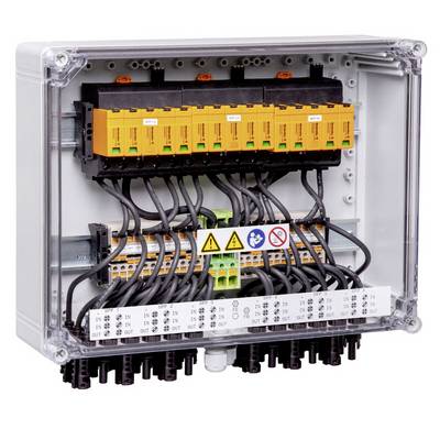 Elektrický ovládací panel s oranžovými a bílými svorkovnicemi, propojeným vedením a bezpečnostními výstražnými štítky uvnitř průhledného krytu.