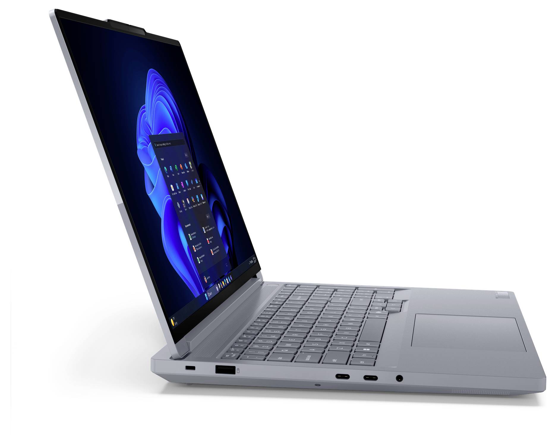 Stříbrný notebook zobrazený otevřený v úhlu s modrým desktopem Windows zobrazeným na obrazovce.