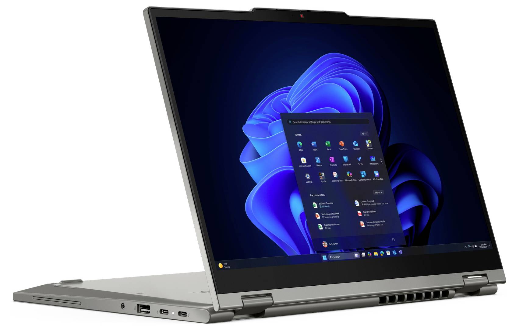 Stříbrný konvertibilní laptop zobrazený v otevřené poloze stan, na kterém je vidět plocha Windows 11 s nabídkou Start uprostřed obrazovky.