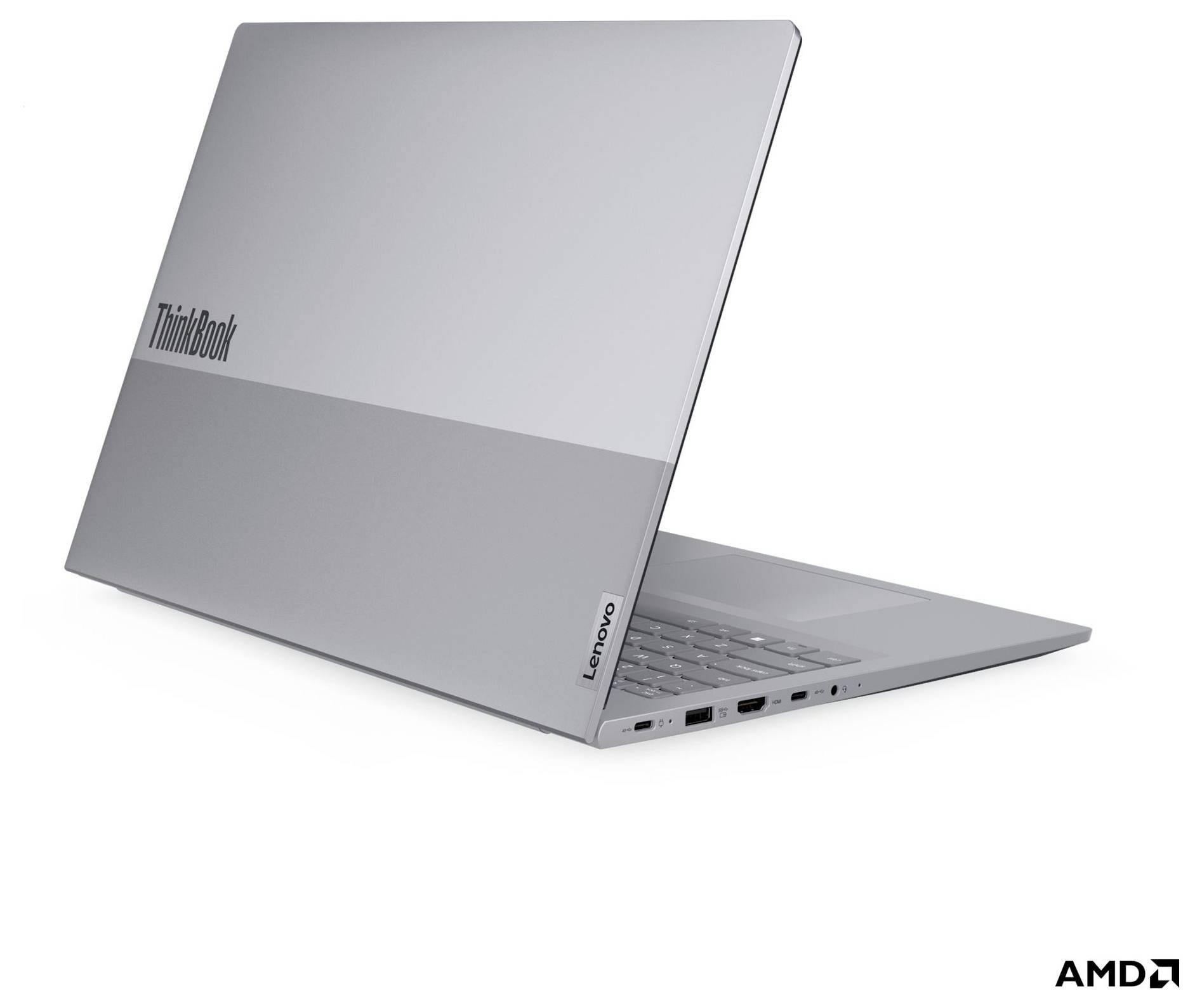 Stříbrný laptop Lenovo ThinkBook zobrazený částečně otevřený na bílém pozadí se značkou AMD.