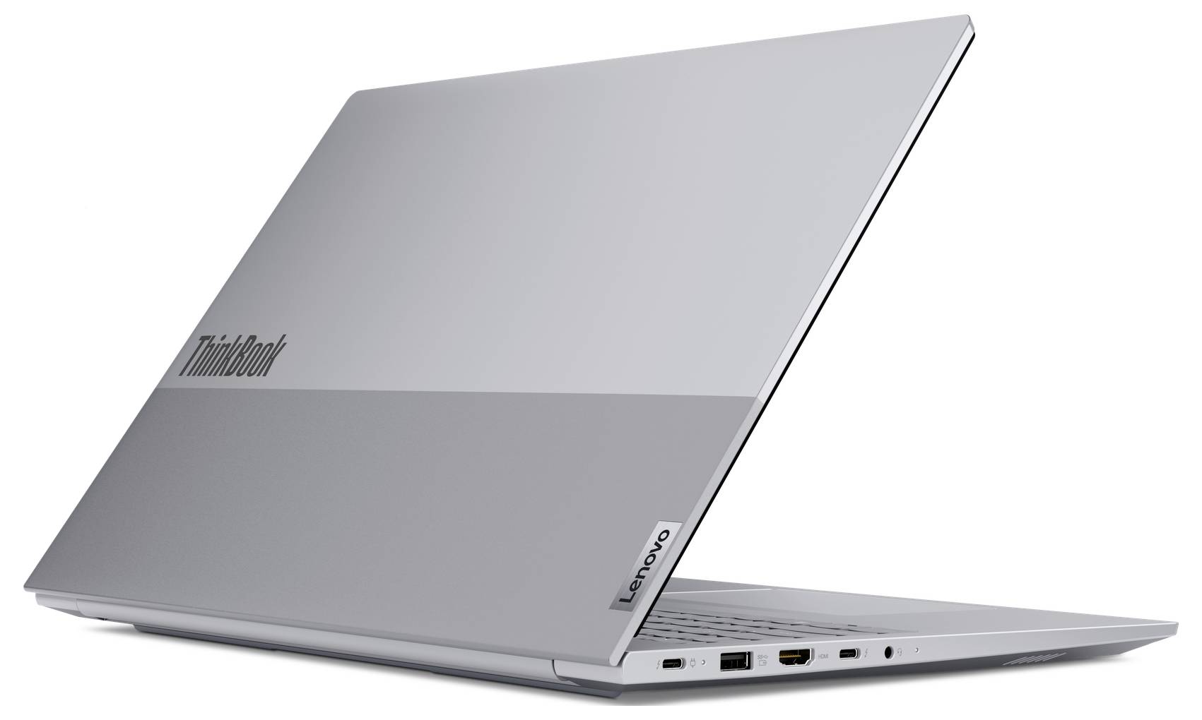 Stříbrný notebook Lenovo ThinkBook částečně otevřený na bílém pozadí, ukazující boční porty a klávesnicovou část.