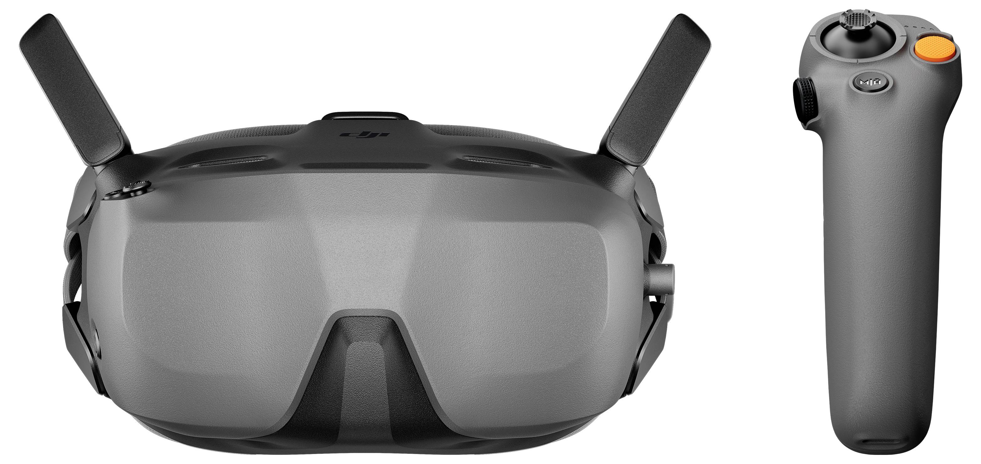 Šedá FPV dronová brýle s dvěma anténami a odpovídajícím bezdrátovým ovladačem zobrazené vedle sebe na bílém pozadí.