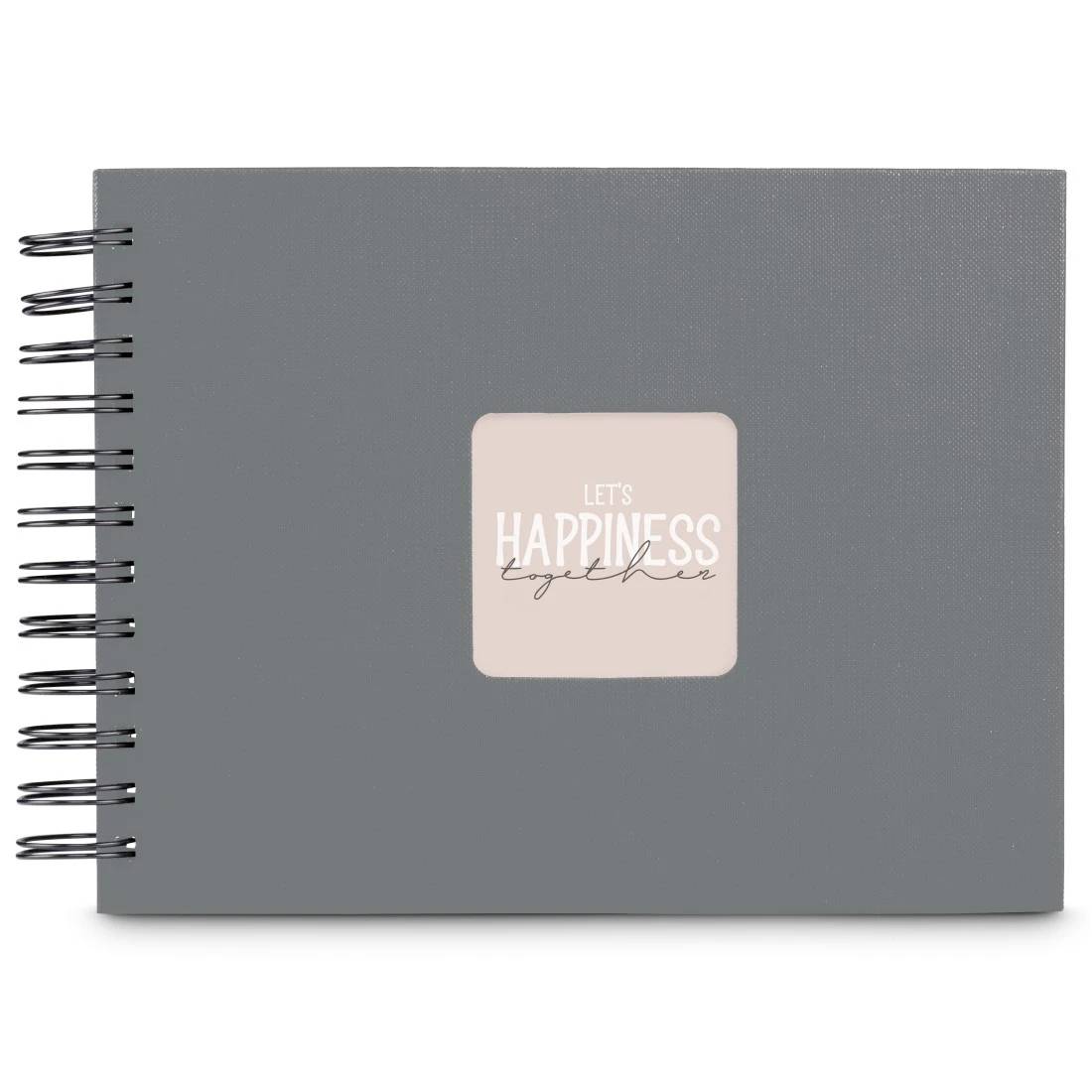 Šedý zápisník se spirálovou vazbou a růžovým štítkem s nápisem „LET'S HAPPINESS together" na obálce.
