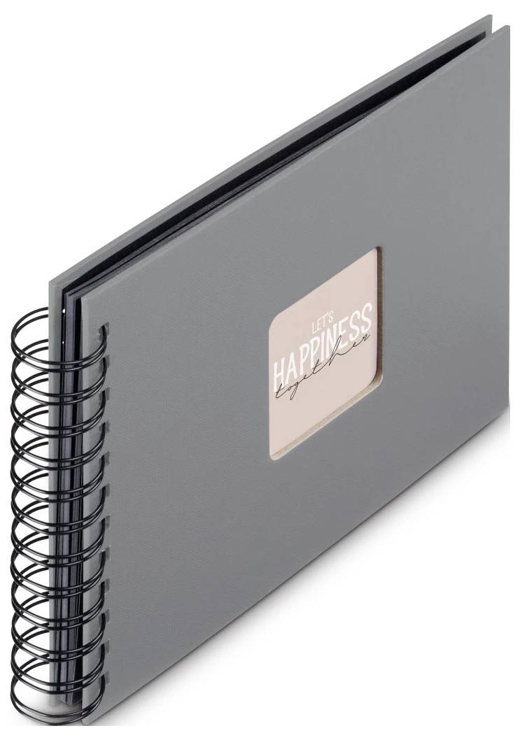 Šedý scrapbook nebo fotoalbum se spirálovou vazbou s malým štítkem na obálce s nápisem „LET'S HAPPINESS" na rovném bílém pozadí.