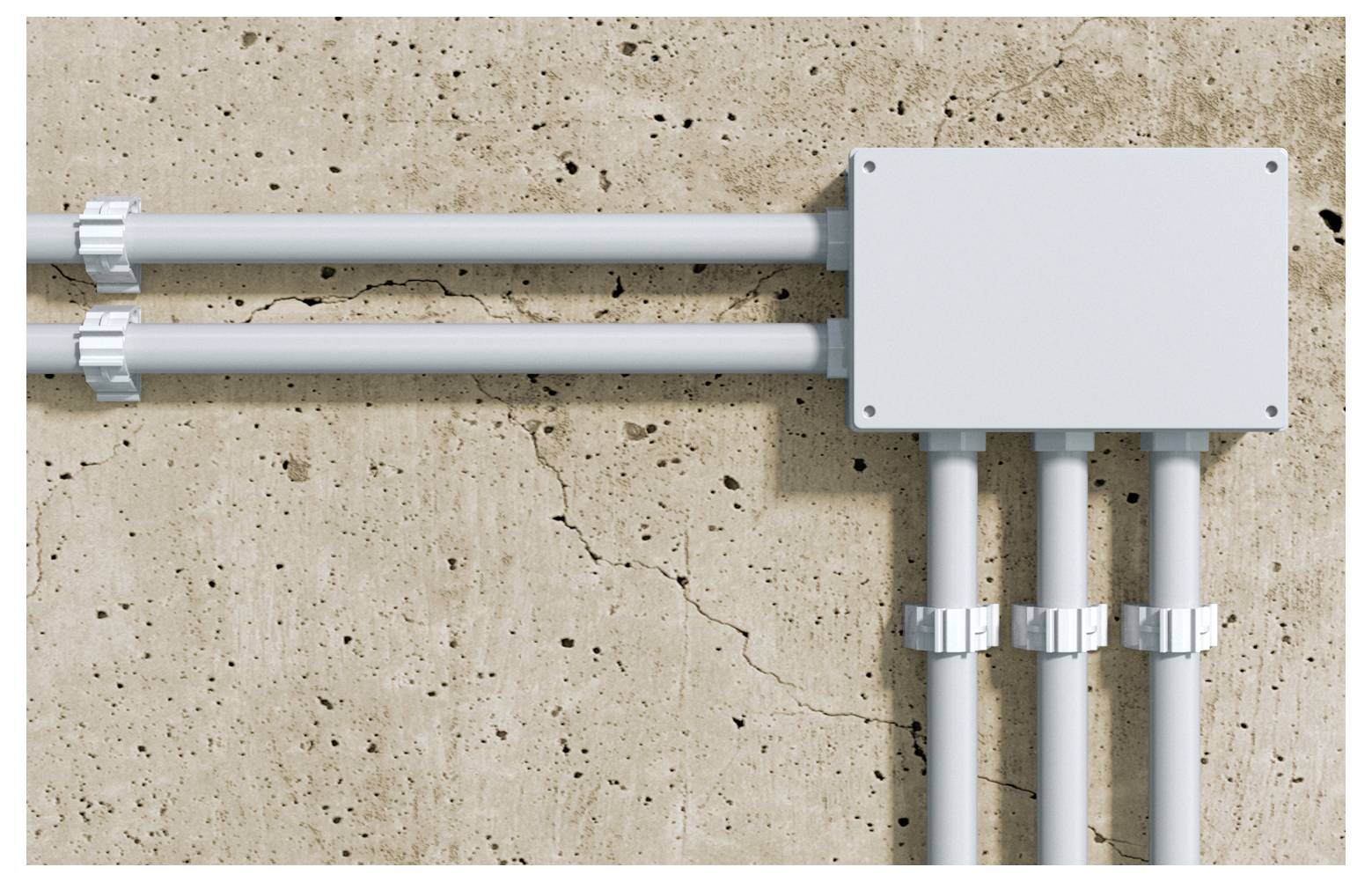 Elektrické trubky vedení vstupující do krabice pro spojení připevněné na betonové zdi.