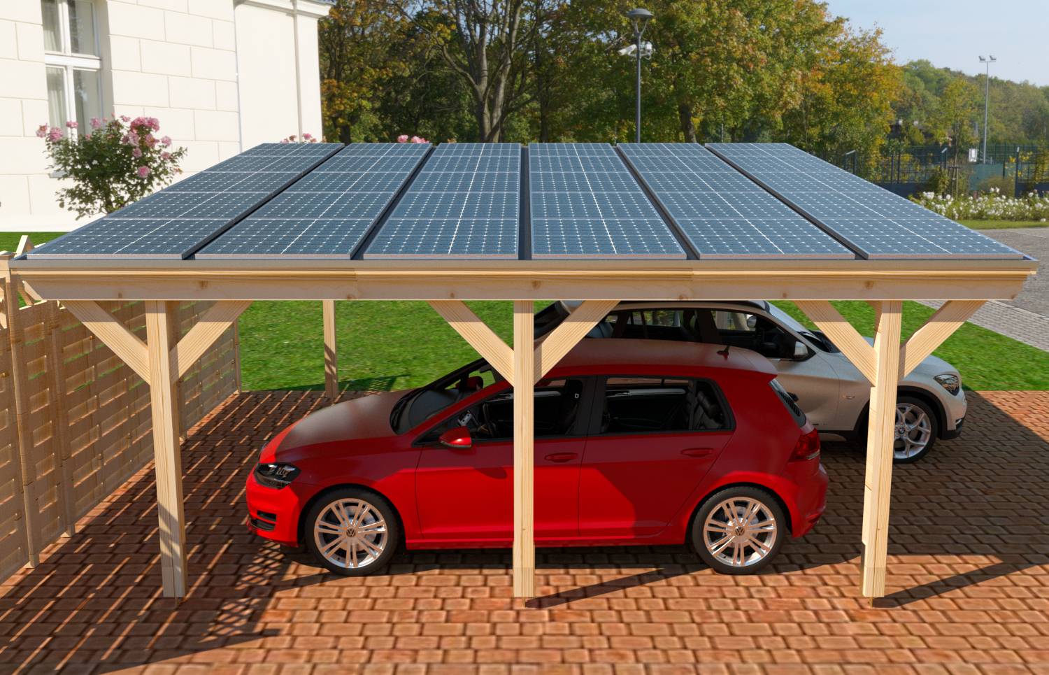 Přístřešek se solárními panely chránící dva zaparkovaná auta, včetně červeného hatchbacku, na dlážděné příjezdové cestě.
