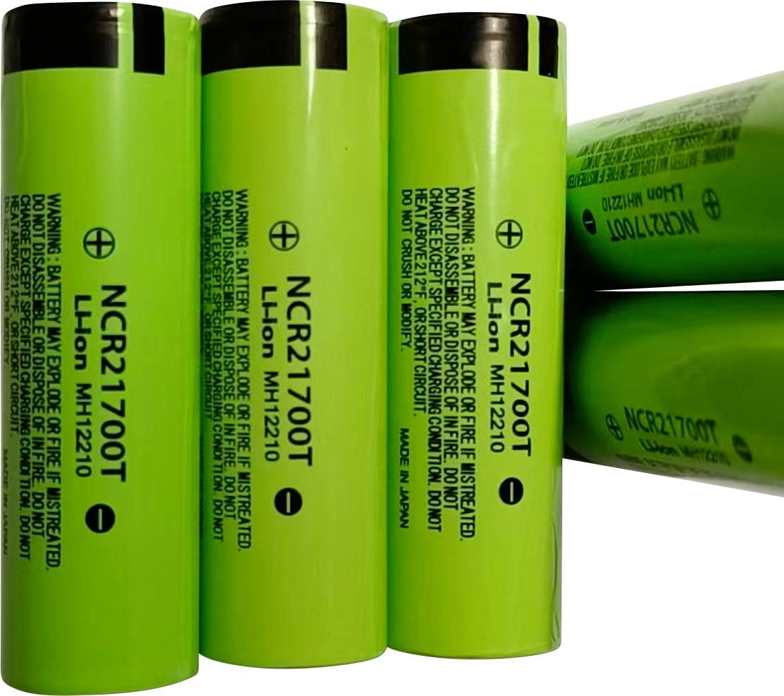 Čtyři zelené baterie NCR21700T lithium-iontové články, zobrazené vzpřímeně a naskládané na svých stranách, s vytištěným varovným a modelovým textem.
