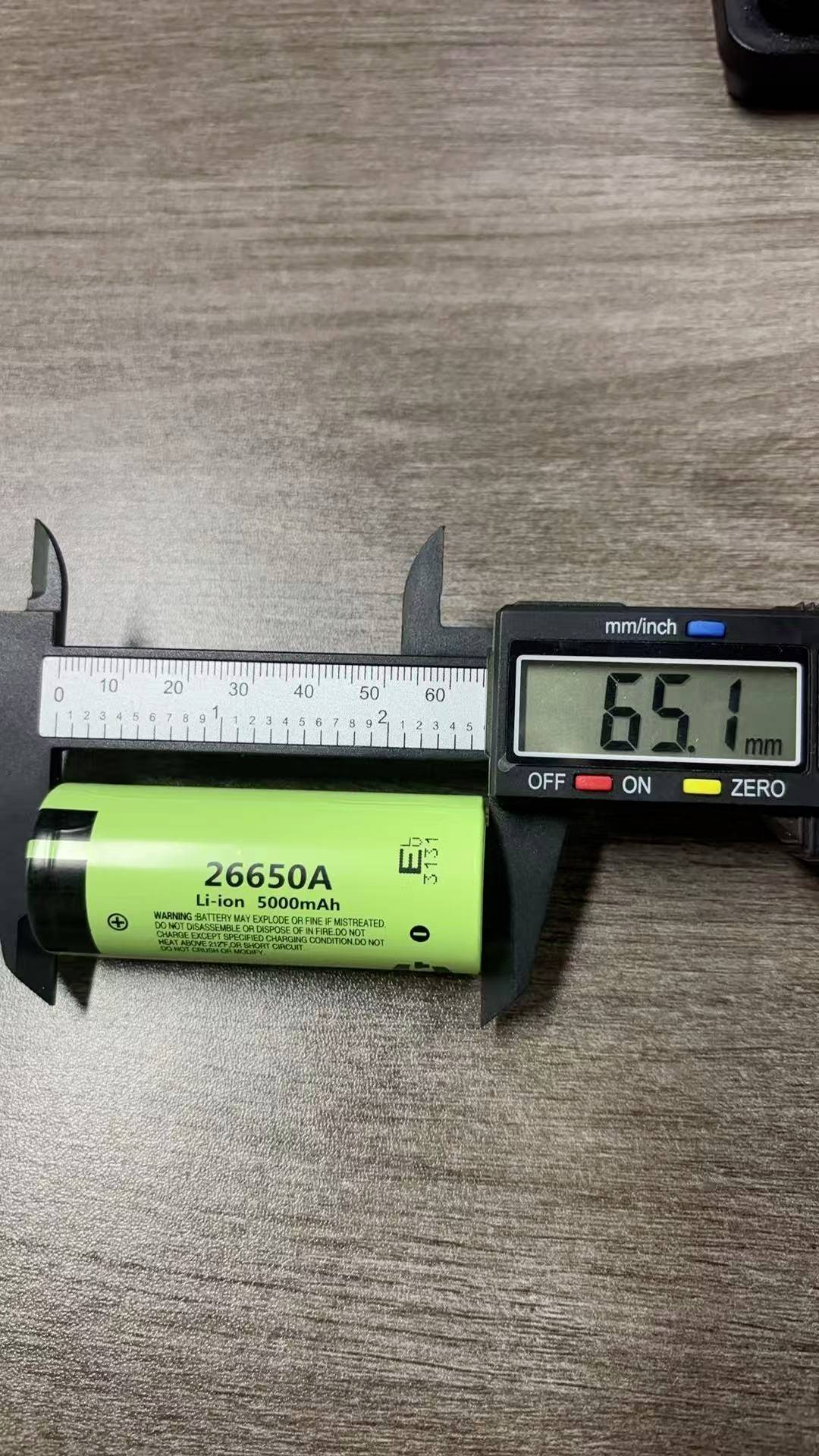 Digitální posuvné měřítko měří zelenou baterii 26650 Li-ion s průměrem 65,1 mm.