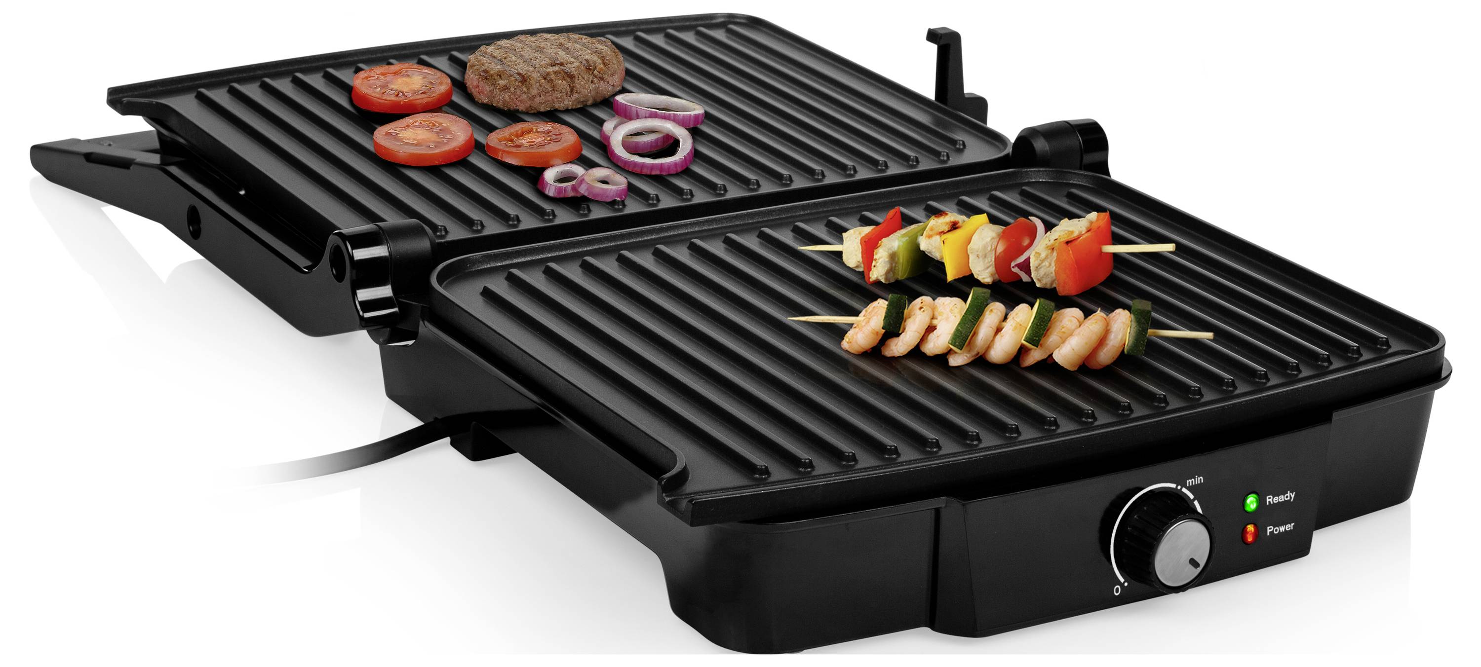 Černý elektrický stolní gril se dvěma dvojitými grilovacími deskami griluje burger, rajče, cibulové kroužky, špízy a krevetky.