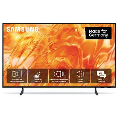 Samsung televizní displej s oranžovou abstraktní obrazovkou, logem Samsung, odznakem "Made for Germany" a ikonami pro QLED, Mini-LED, TV Plus, Air Slim Design a Vision AI Companion.