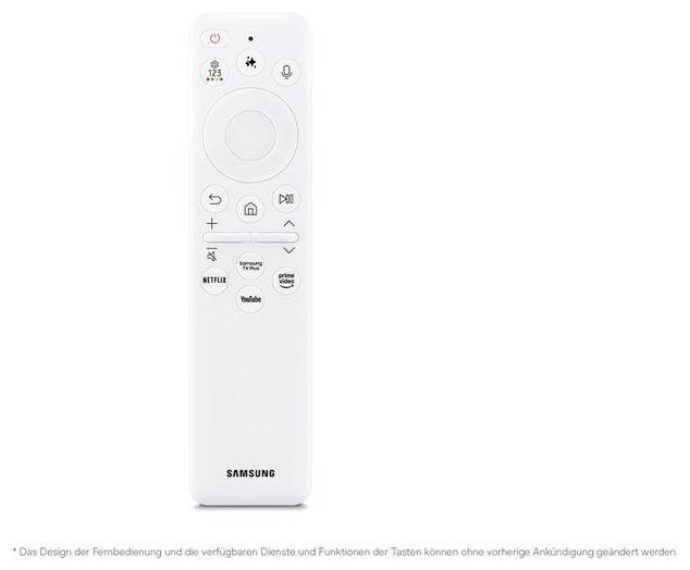 Bílý dálkový ovladač Samsung TV s hlasem, navigační tlačítka, domů, hlasitost, kanály a tlačítka streamovacích aplikací včetně Netflix, YouTube, Prime Video a Samsung TV Plus.