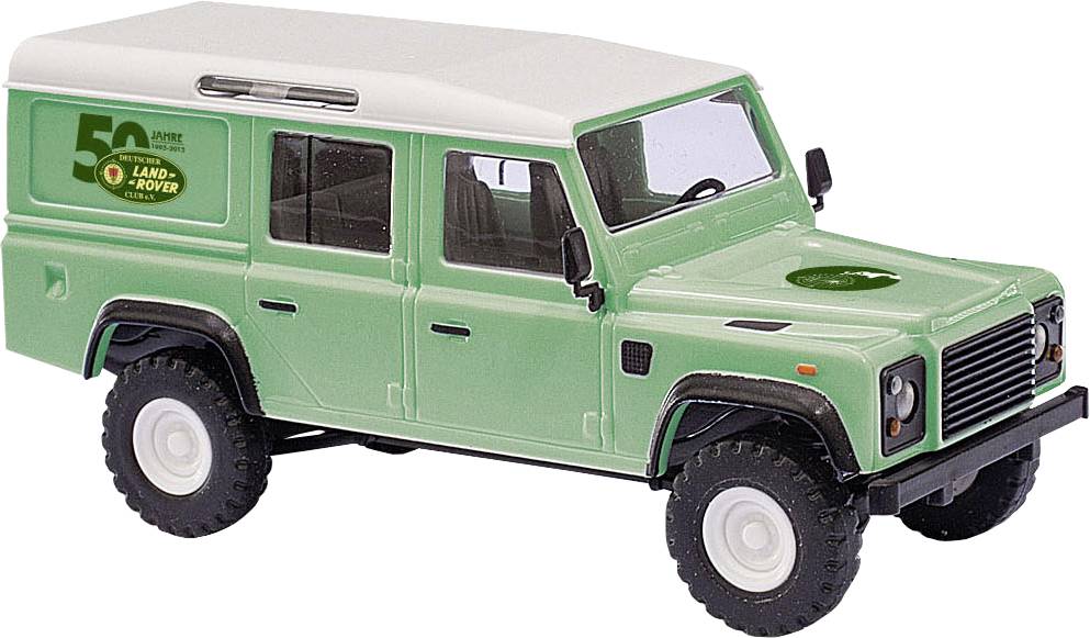Zelený model hraček Land Rover Defender se smetanovovou střechou, zobrazen v bočním pohledu na bílém pozadí.