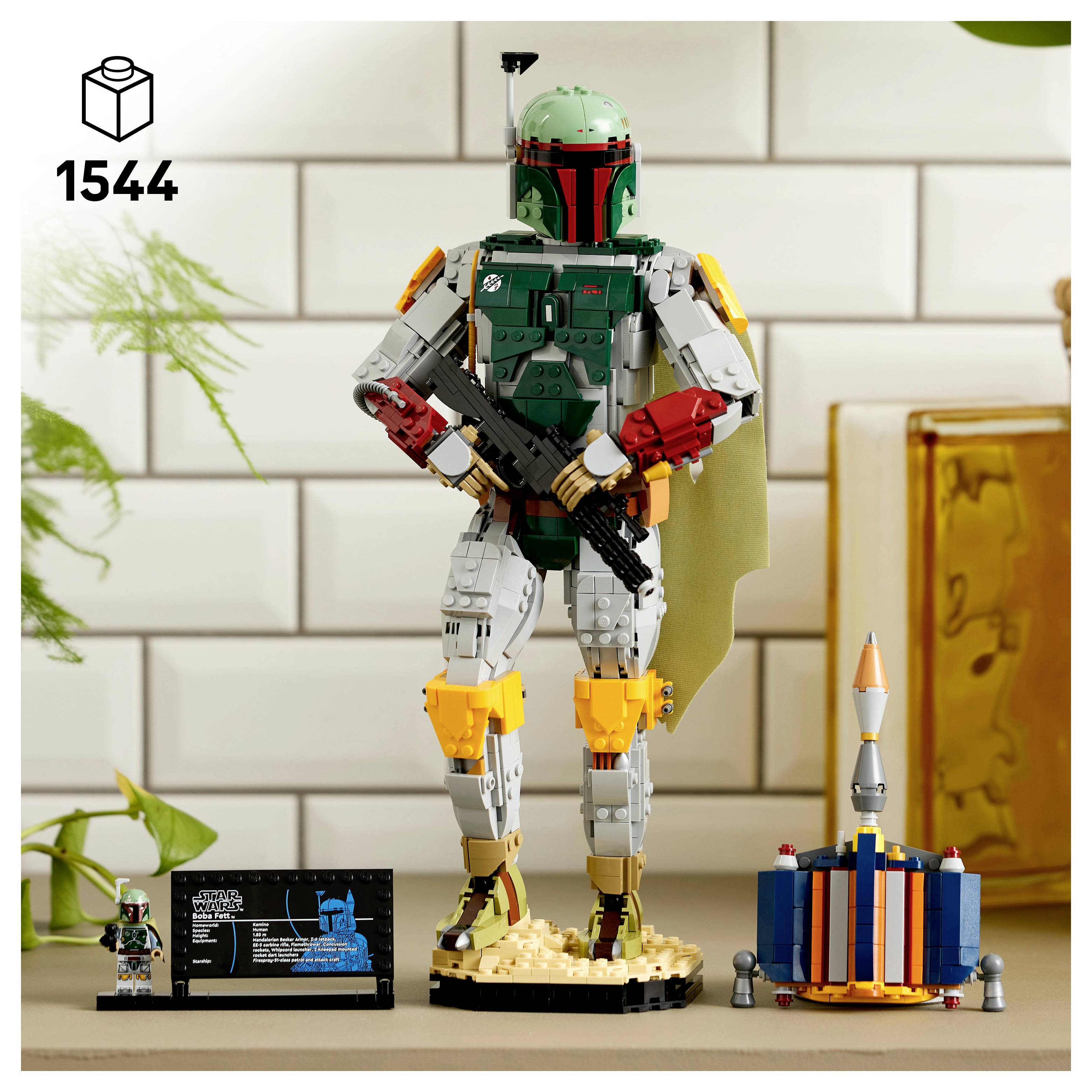 LEGO Star Wars model Boba Fett určený k vystavení s cedulí a číslem 1544, znázorňující přilbou vybaveného lovec odměn stojícího na podstavci s přilbou a malými stavebnicemi vedle něj.