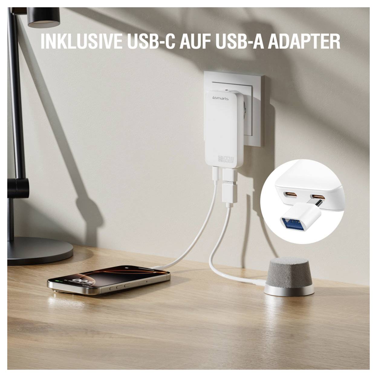 USB-C na USB-A adaptér zapojený do síťového nabíječky, připojující smartphone na stole; vložený obrázek ukazuje porty USB-C a USB-A adaptéru.