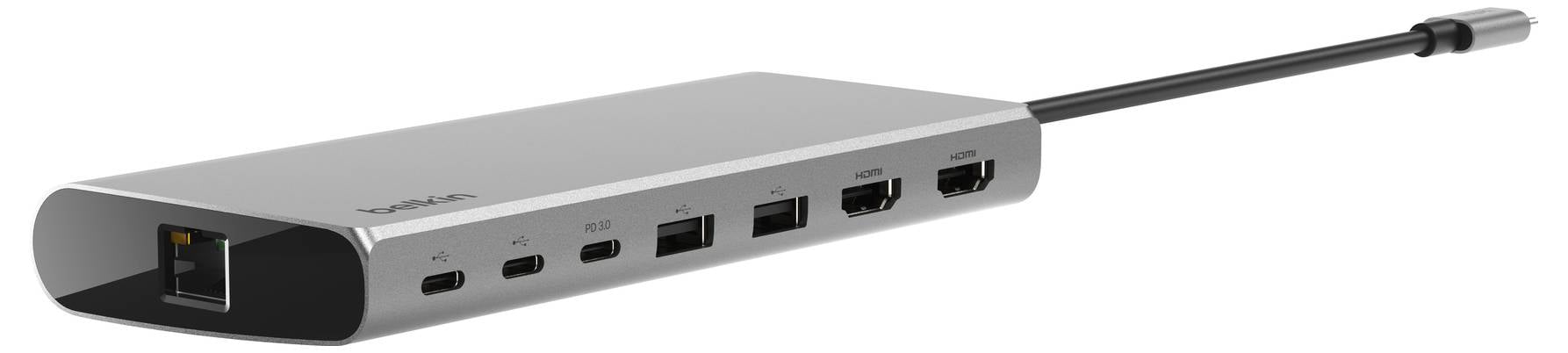 Stříbrná multifunkční USB-C dokovací stanice s porty Ethernet, USB, HDMI a audio na bílém pozadí.