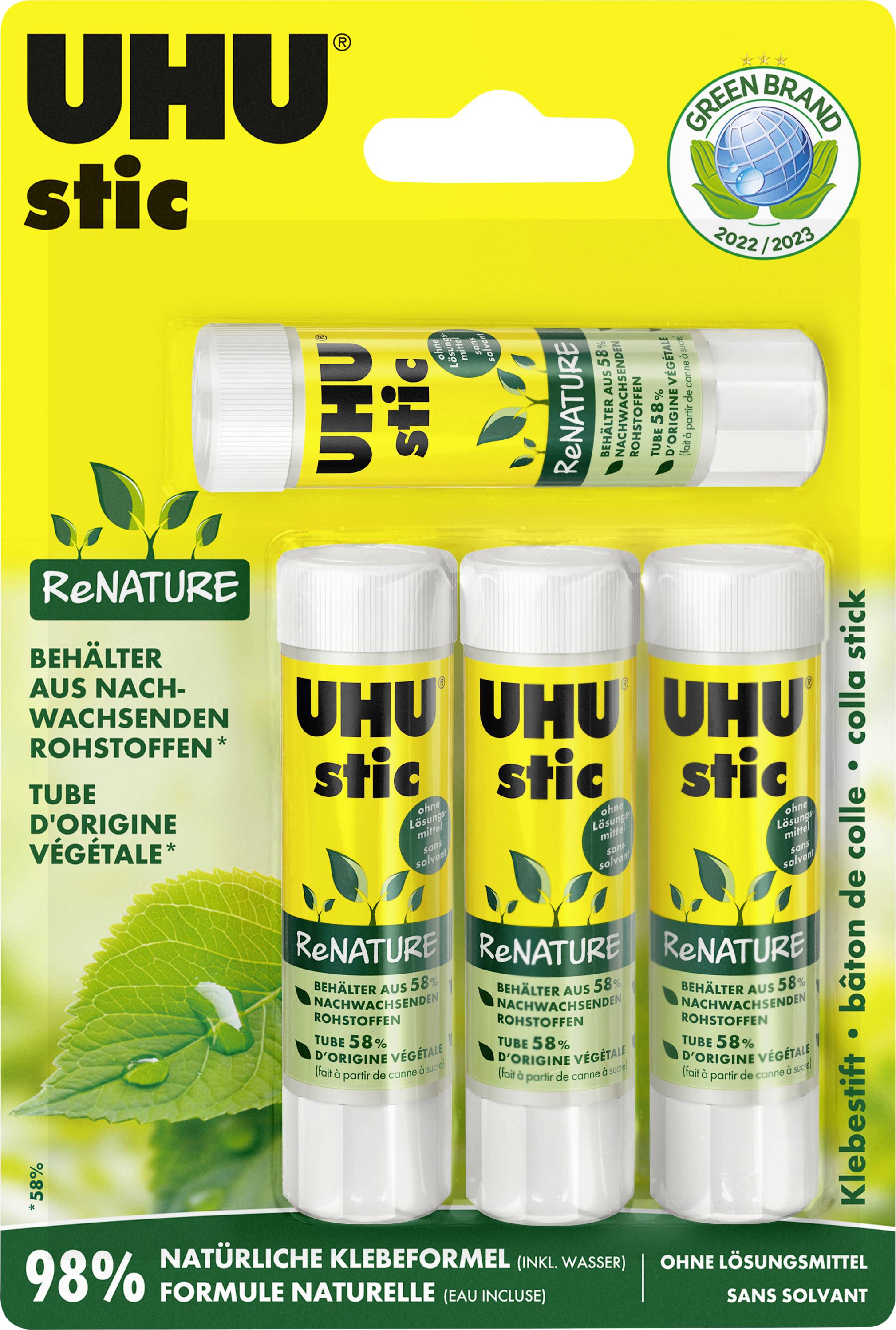 UHU stic ReNature lepidlo v tyčince v balení na žluté obálce, zobrazující jednu velkou tyčinku a tři malé tyčinky, s nápisem „98% přírodní lepící formule" a ekologickou značkou.