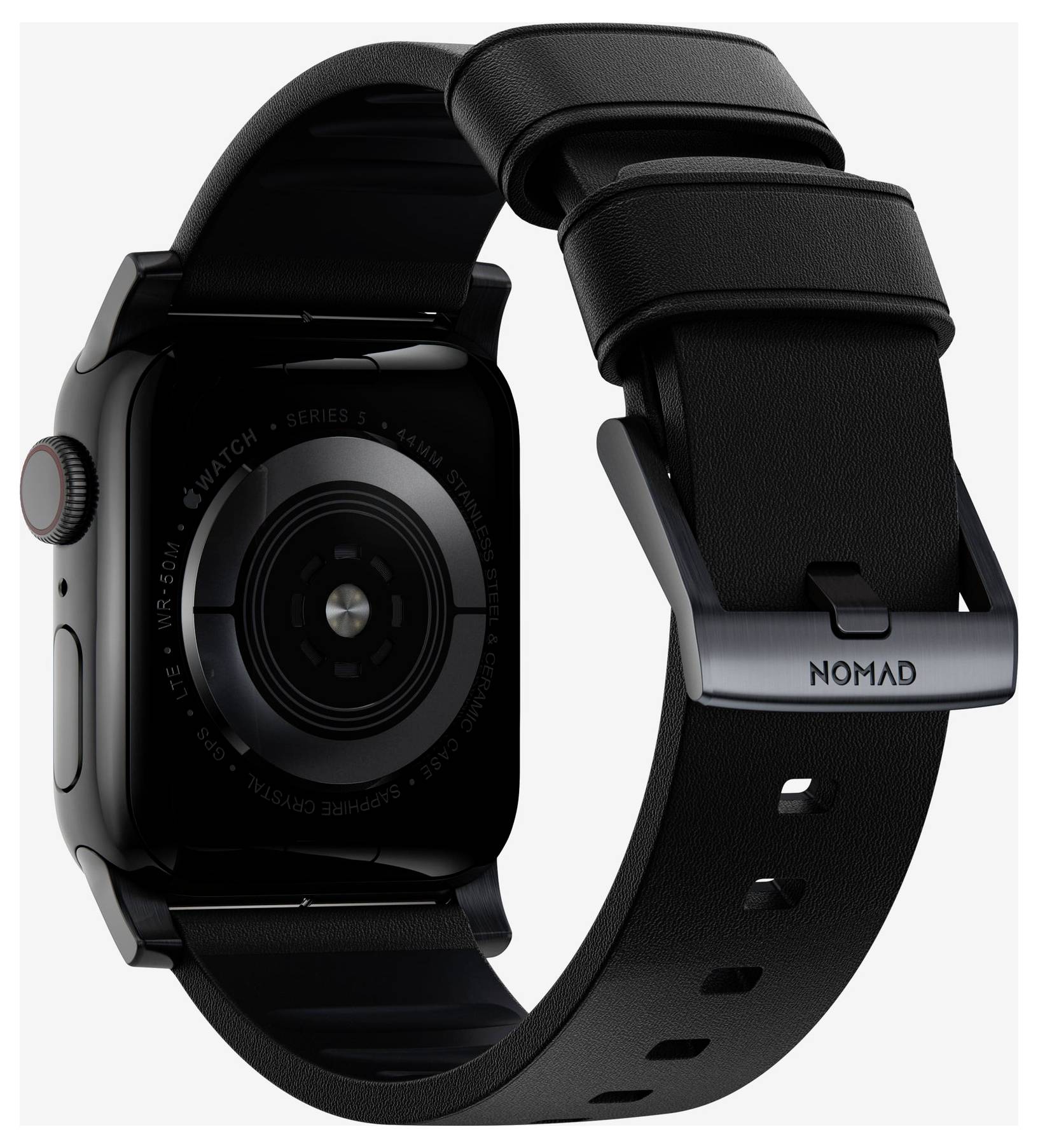 Černé Apple Watch zobrazené zezadu s černým páskem Nomad a kovovou přezkou, zobrazující kruhový senzor a postranní korunku.