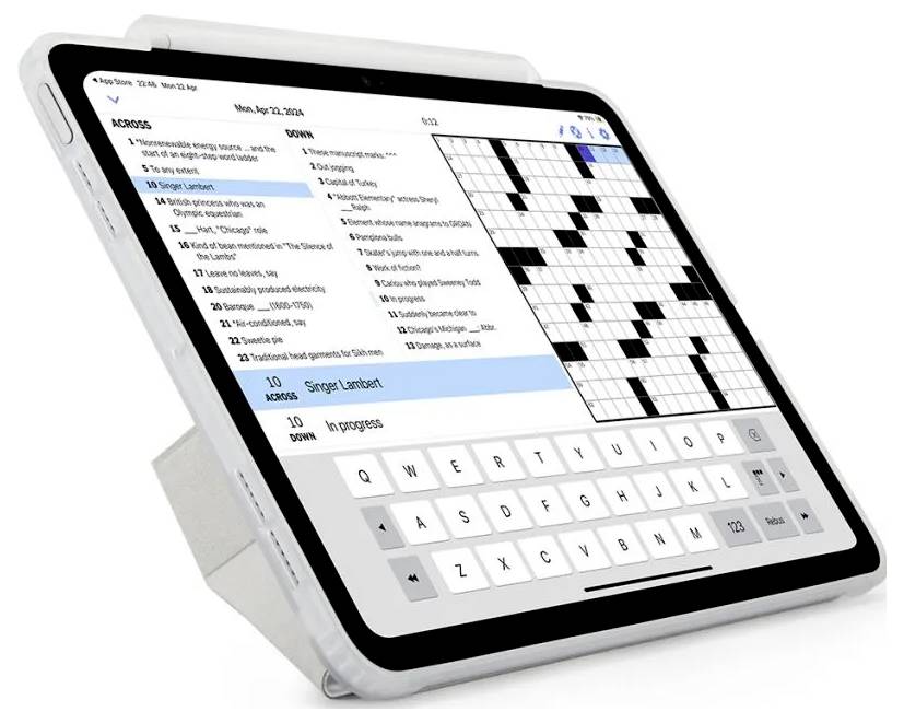 Tablet se zobrazenou aplikací křížovky s nápovědami vlevo, mřížkou hádanky vpravo a virtuální klávesnicí na spodní straně.
