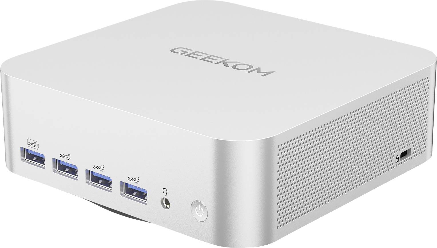 Stříbrný GEEKOM mini PC se čtyřmi předními porty USB, jack pro sluchátka, tlačítkem napájení a děrovanými bočními ventilačními otvory na bílém pozadí.
