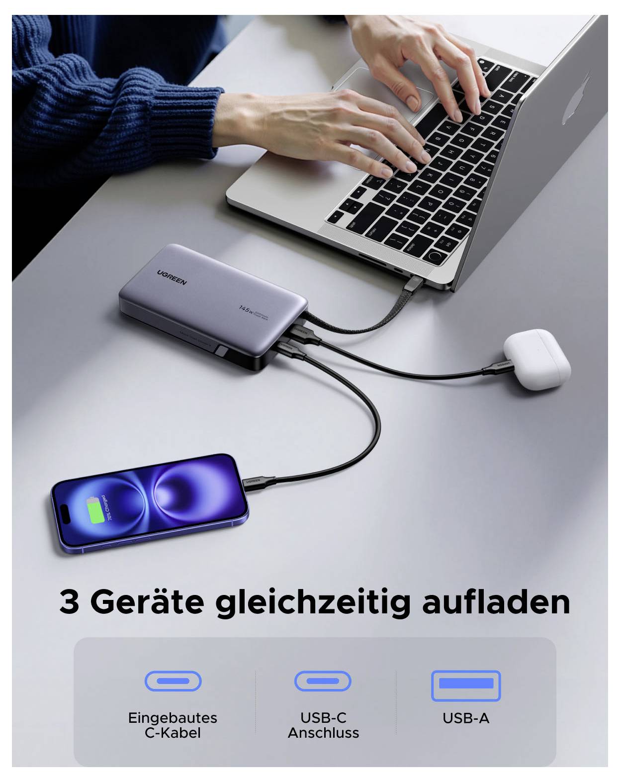 Přenosný počítač připojený k rozbočovači pro nabíjení 3 zařízení napájející telefon a sluchátka; německý text říká „Nabíjejte 3 zařízení najednou" s vestavěným kabelem C, USB-C a USB-A.