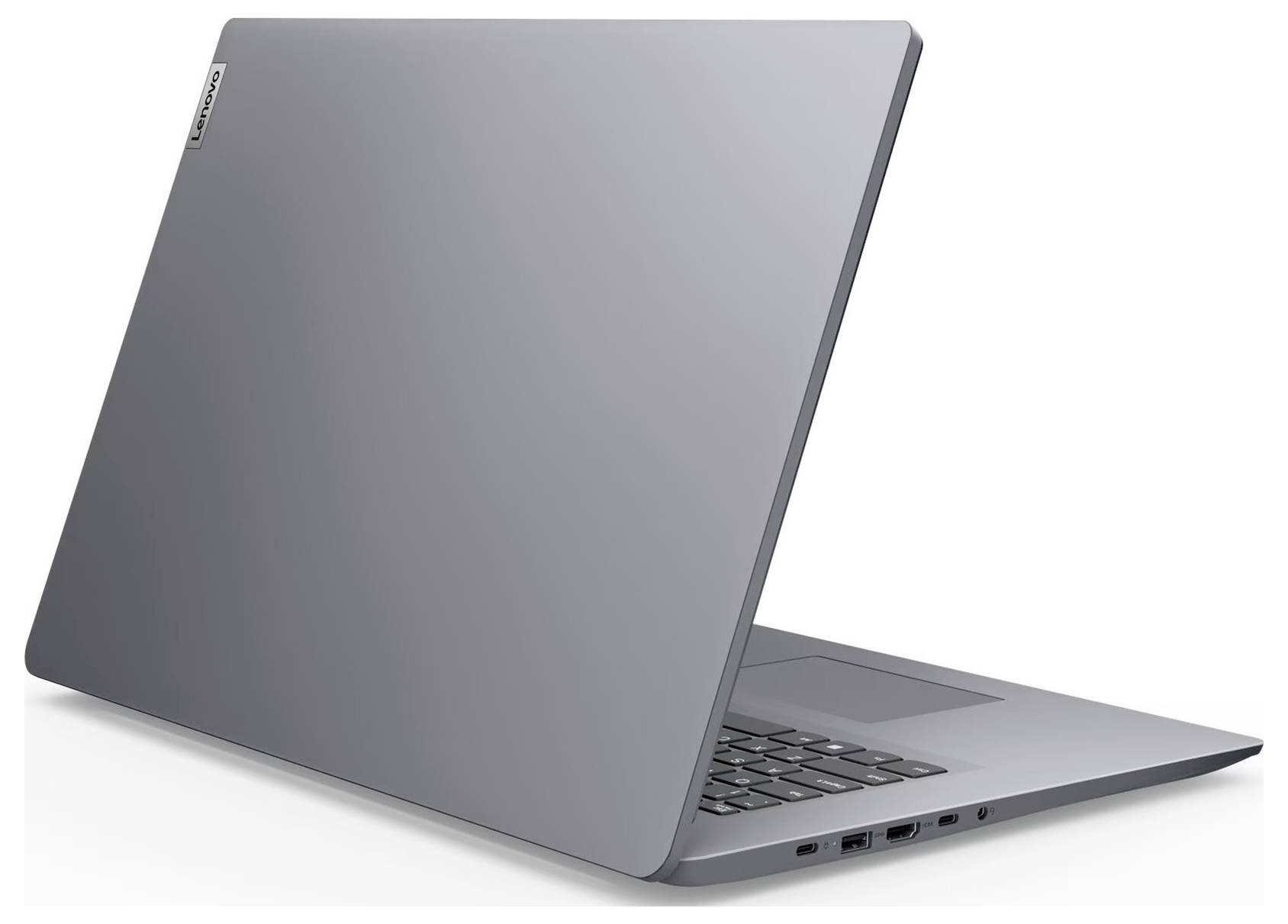 Zavřený stříbrný notebook zobrazený v pohledu zezadu ze tří čtvrtin, s částečně viditelnou klávesnicí a bočními porty na jednoduchém bílém pozadí.