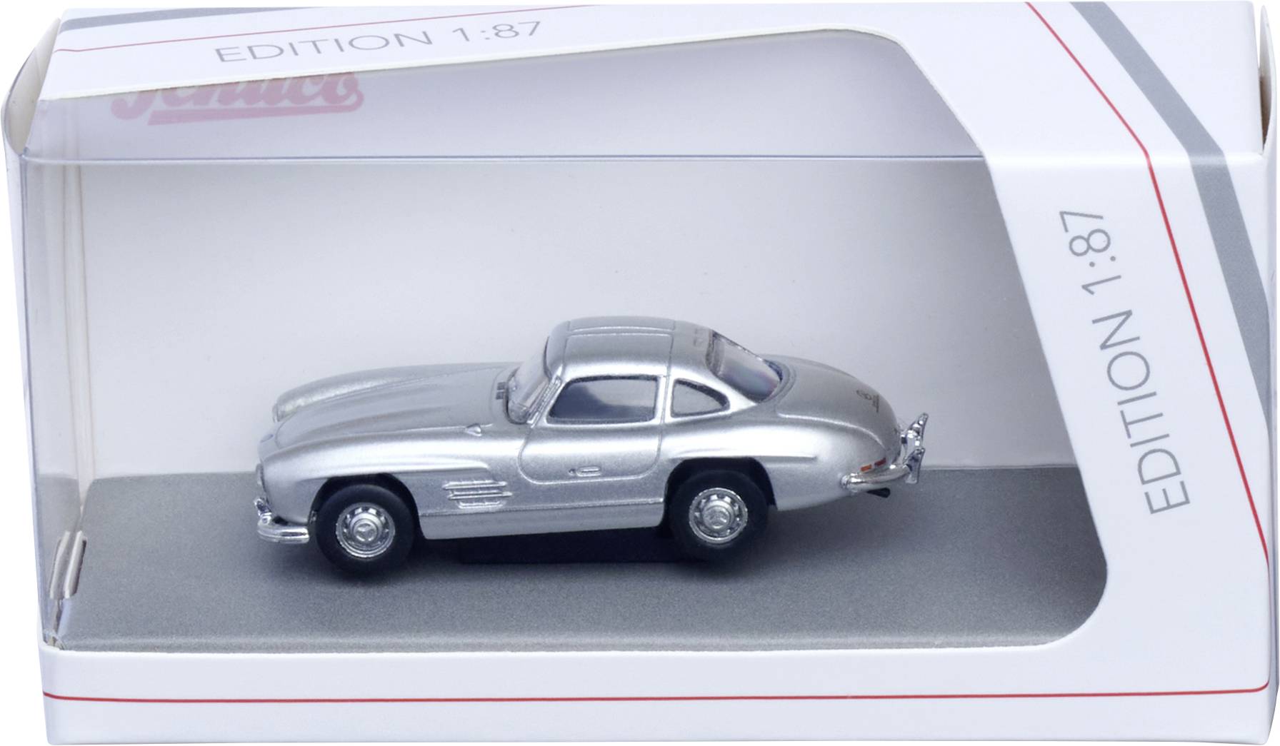 Stříbrný modelový automobil v krabici s nálepkou "Edition 1:87" s průhledným plastovým oknem.