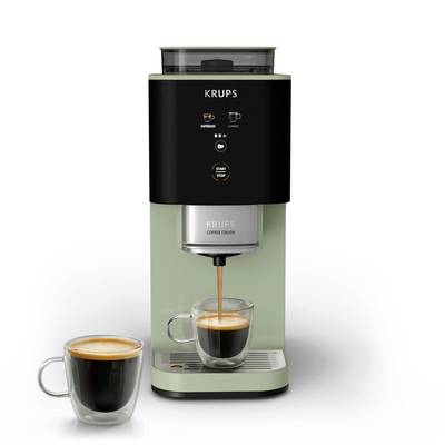 Kávovaru KRUPS, který nalévá espresso do sklenice, s naplněnou sklenicí vedle něj na bílém pozadí.