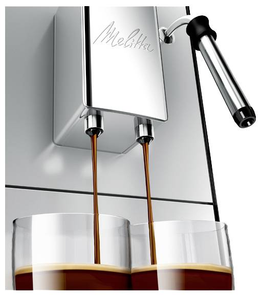 Stříbrný espresso stroj značky „Melitta" nalévá dva proudy kávy do dvou sklenic.