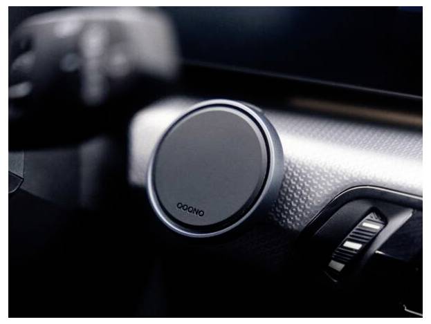 Detailní záběr na ovládací kolečko na palubní desce automobilu s texturovaným kovovým povrchem, pravděpodobně pro regulaci klimatizace nebo zvuku.