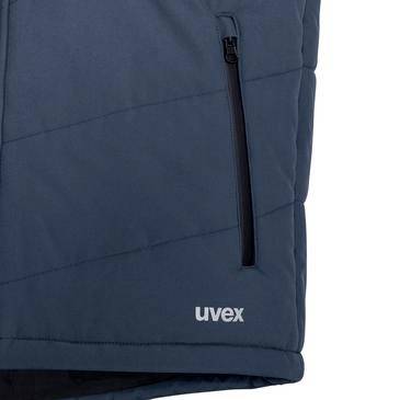 Detailní pohled na lemování tmavě modré prošívané bundy uvex se svislou kapsou na zip.