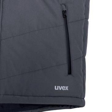 Detailní snímek tmavě šedé části bundy Uvex s vertikální kapsou na zip a viditelným logem 'uvex'.