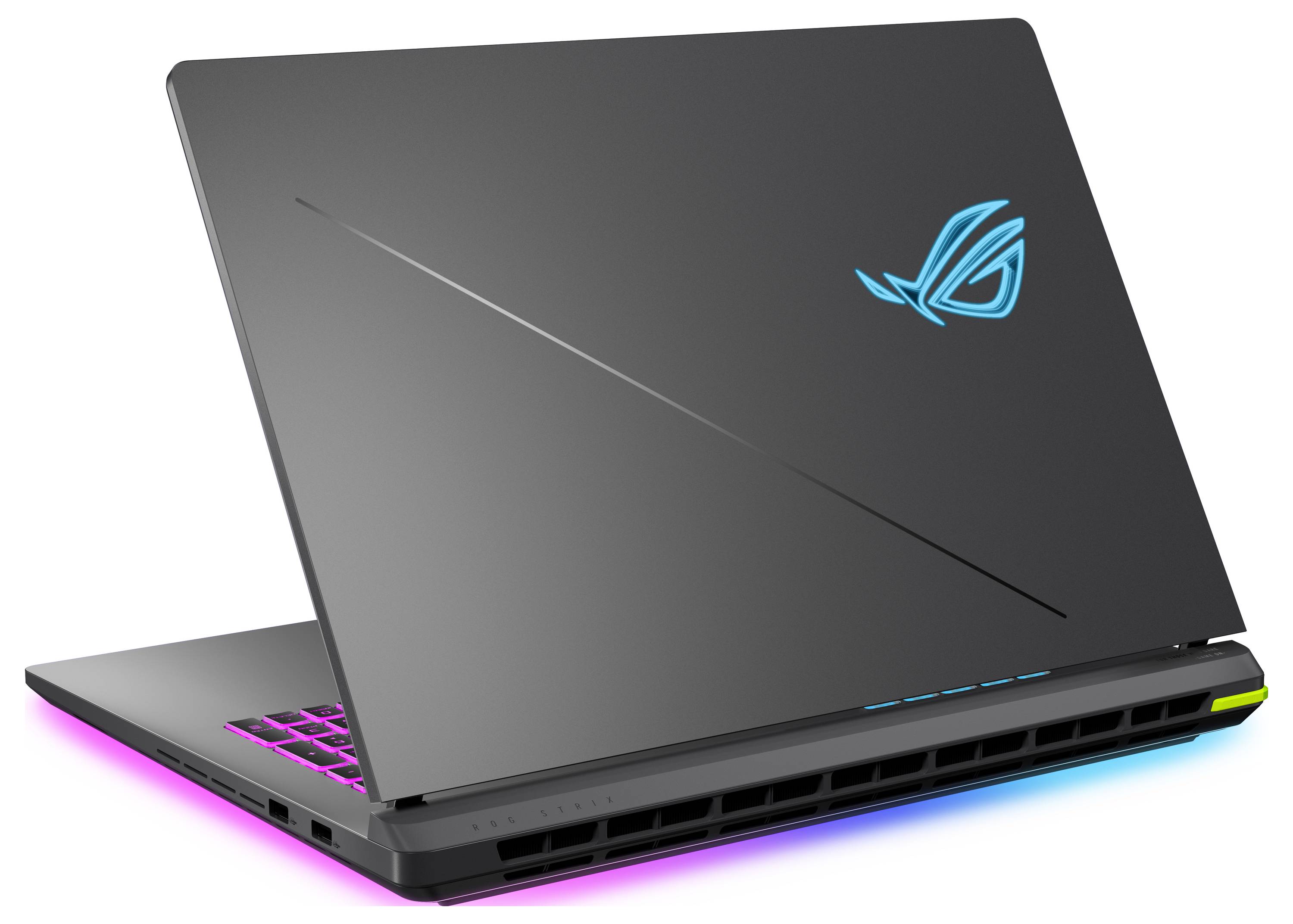 Zavřený černý herní notebook s podsvícenou RGB klávesnicí a modrozelným logem, zobrazený v úhlu na bílém pozadí.
