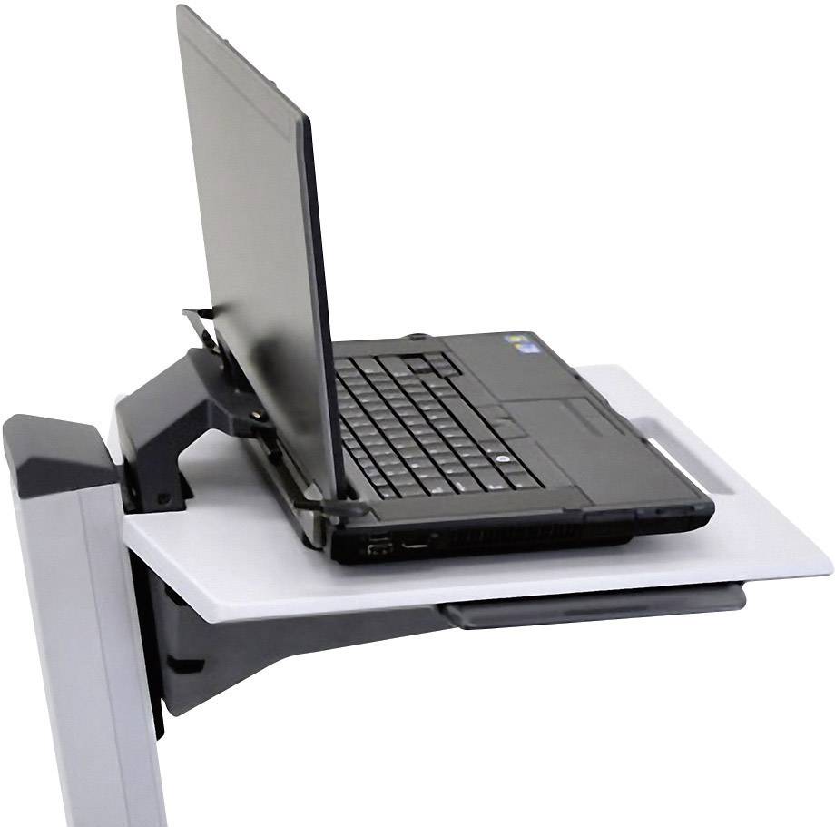Notebook leží na sklopném stole upevněném na stěně. Stůl slouží jako úsporné pracovní místo.