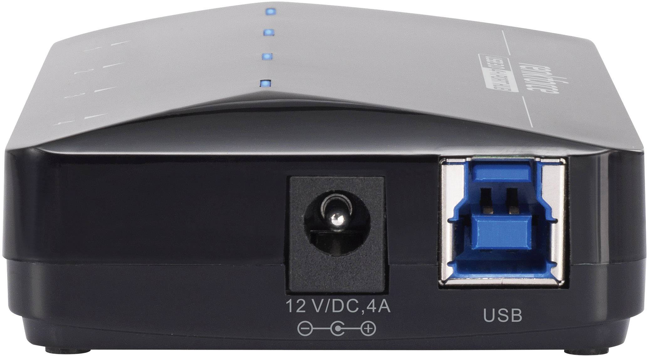 Černé síťové zařízení s USB portem a napájecím konektorem 12V/DC 4A. Nahoře je vidět několik modrých světelných indikátorů.