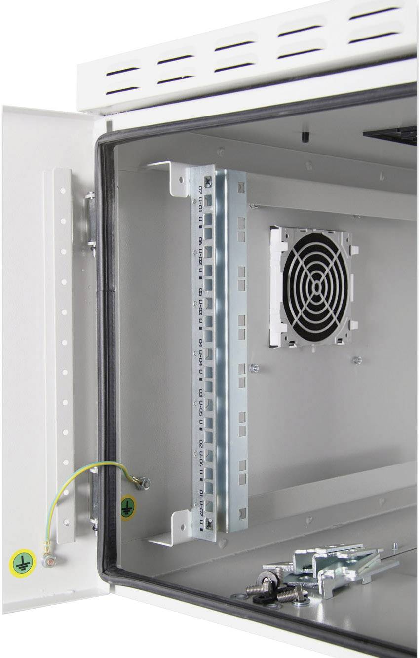 Otevřený kovový kryt s ventilátorem a uzemňovacím kabelem uvnitř. Pravá strana krytu ukazuje montážní lišty pro technické komponenty.