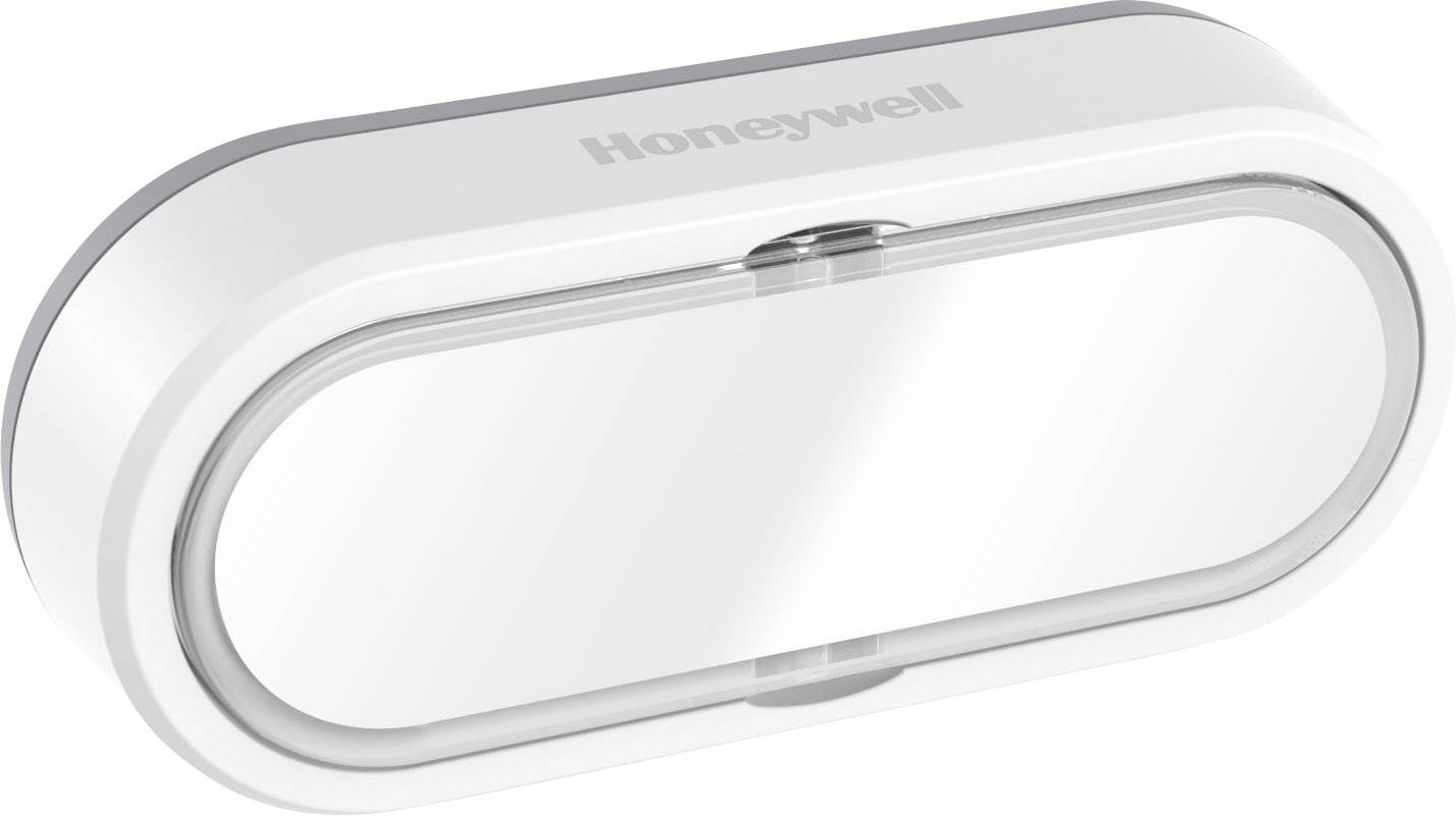 Bílý, oválný senzor na dveře nebo okna od společnosti Honeywell určený k monitorování otevírání a zavírání.