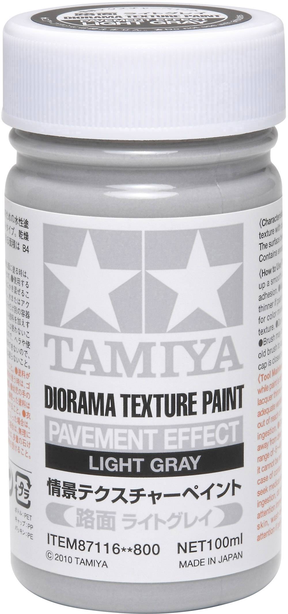 Obrázek ukazuje láhev Tamiya Diorama Texture Paint v světle šedé barvě, 100 ml. Nápis: 'Efekt dlažby'. Vyrobeno v Japonsku.