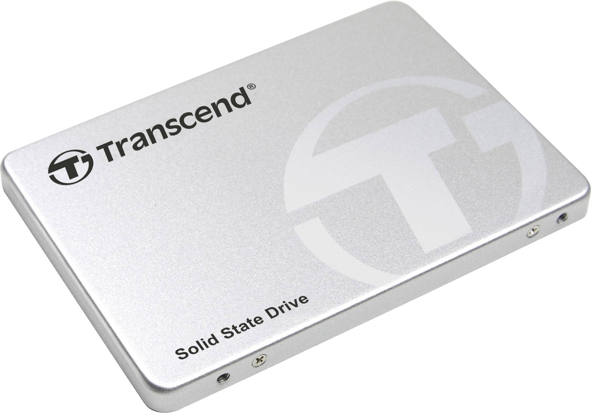 Stříbrný disk Solid State Drive (SSD) značky Transcend s logem a nápisem, ležící na bílém povrchu.