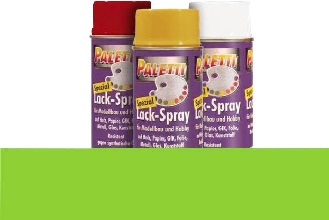 Tři spreje s nápisem 'Paletti Spezial Lack-Spray' před zeleným pozadím. Každá dóza v jiné barvě: červená, žlutá, bílá.