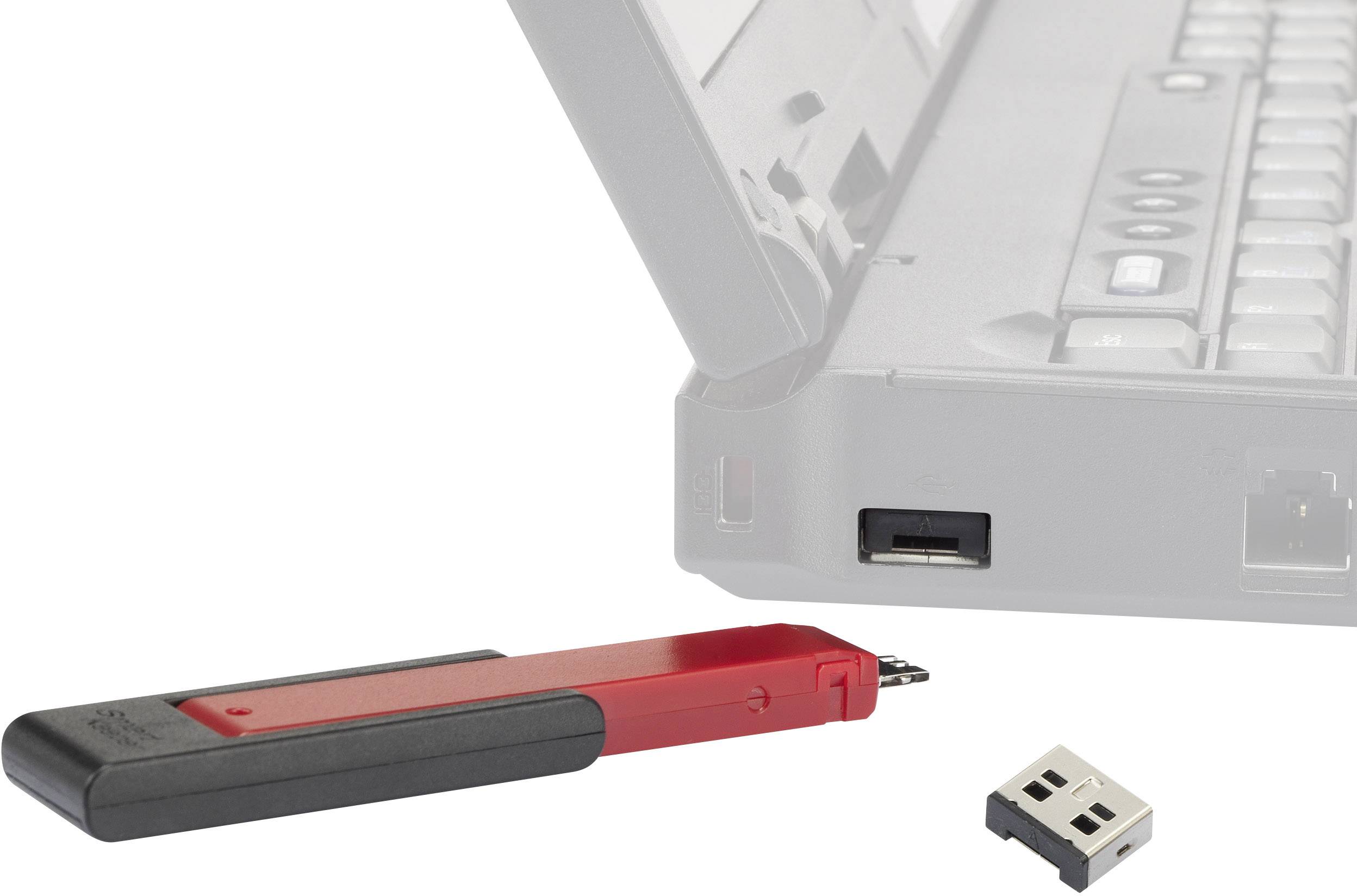 USB dongle a adaptér leží poblíž laptopem. Laptop je lehce otevřený a ukazuje USB porty po straně.