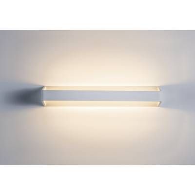 Nástěnná lampa s nepřímým osvětlením vrací teplé, rovnoměrné světlo na stěnu a vytváří útulnou atmosféru.