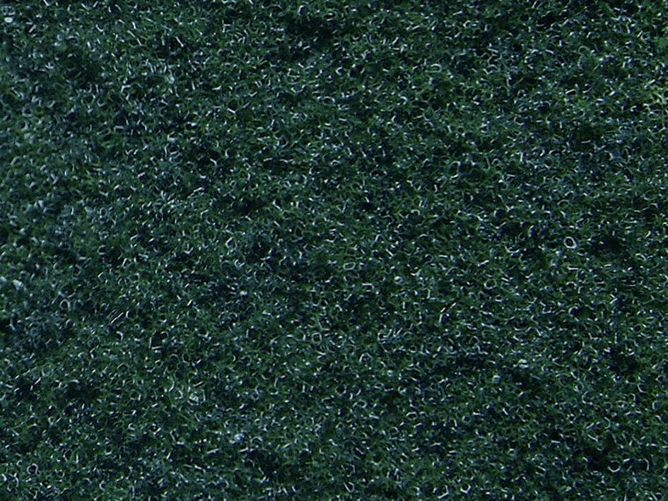 Tmavě zelený, drsně vypadající povrch, který připomíná detailní záběr plsti nebo čalouněné látky.
