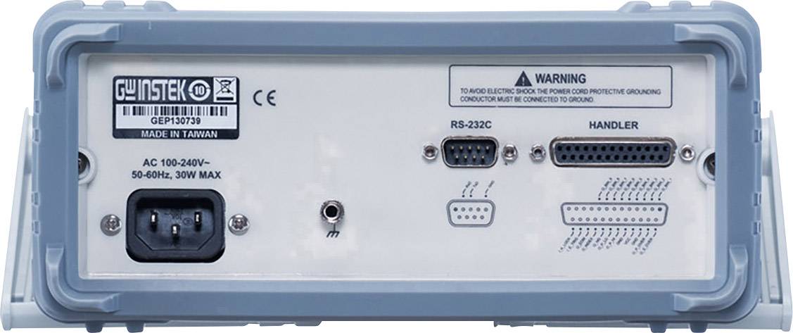 Zadní pohled na elektronické zařízení s různými porty, včetně RS-232C, handlerova portu a napájecího konektoru.