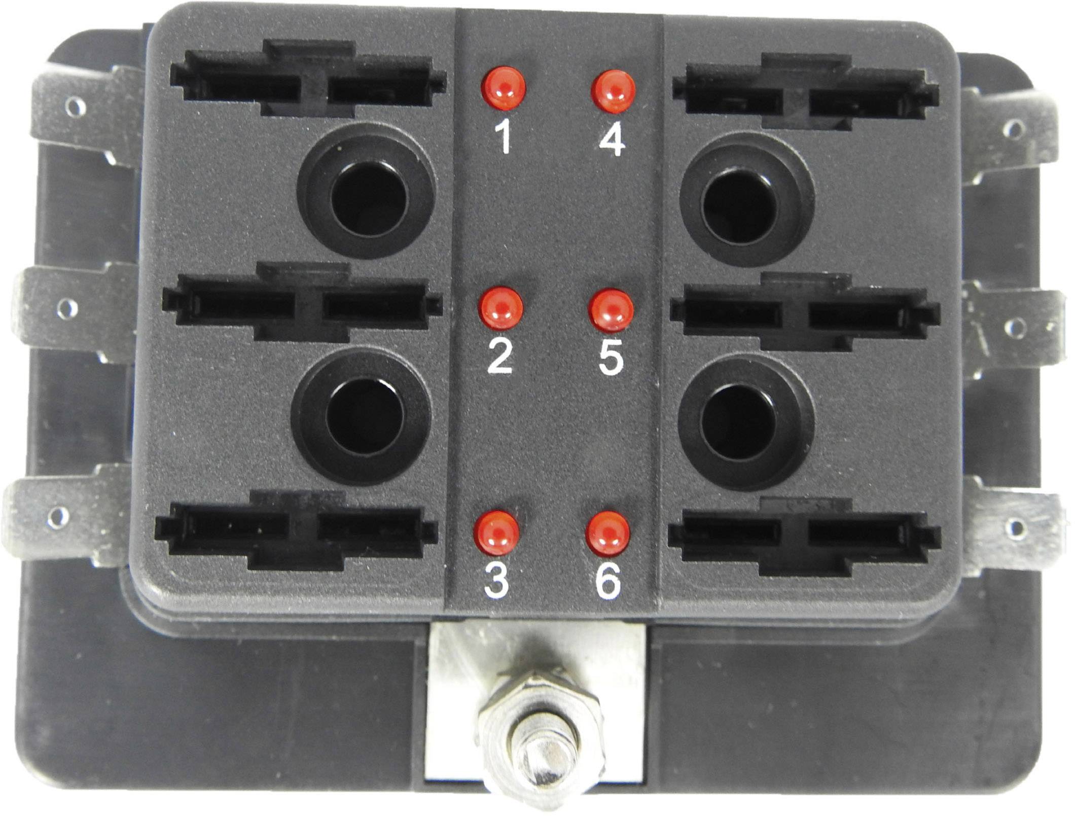 Černá elektrická komponenta s šesti očíslovanými konektory a červenými LED indikátory. Používá se v elektrických systémech pro propojení.