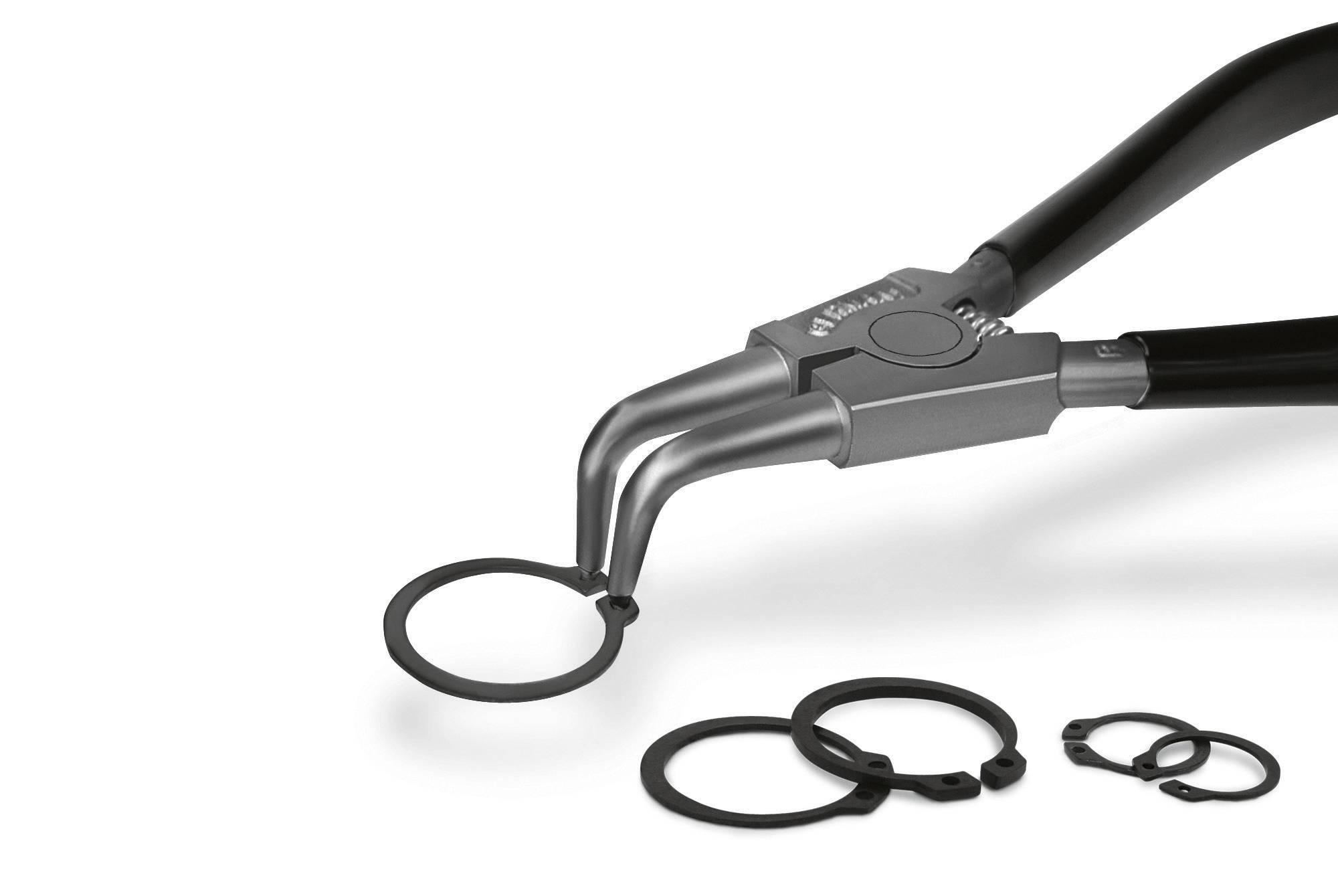 Kleště pro otevírání nebo zavírání pojistných kroužků jsou zde zobrazeny, některé kroužky jsou vedle nich. Vhodné pro mechanické práce.