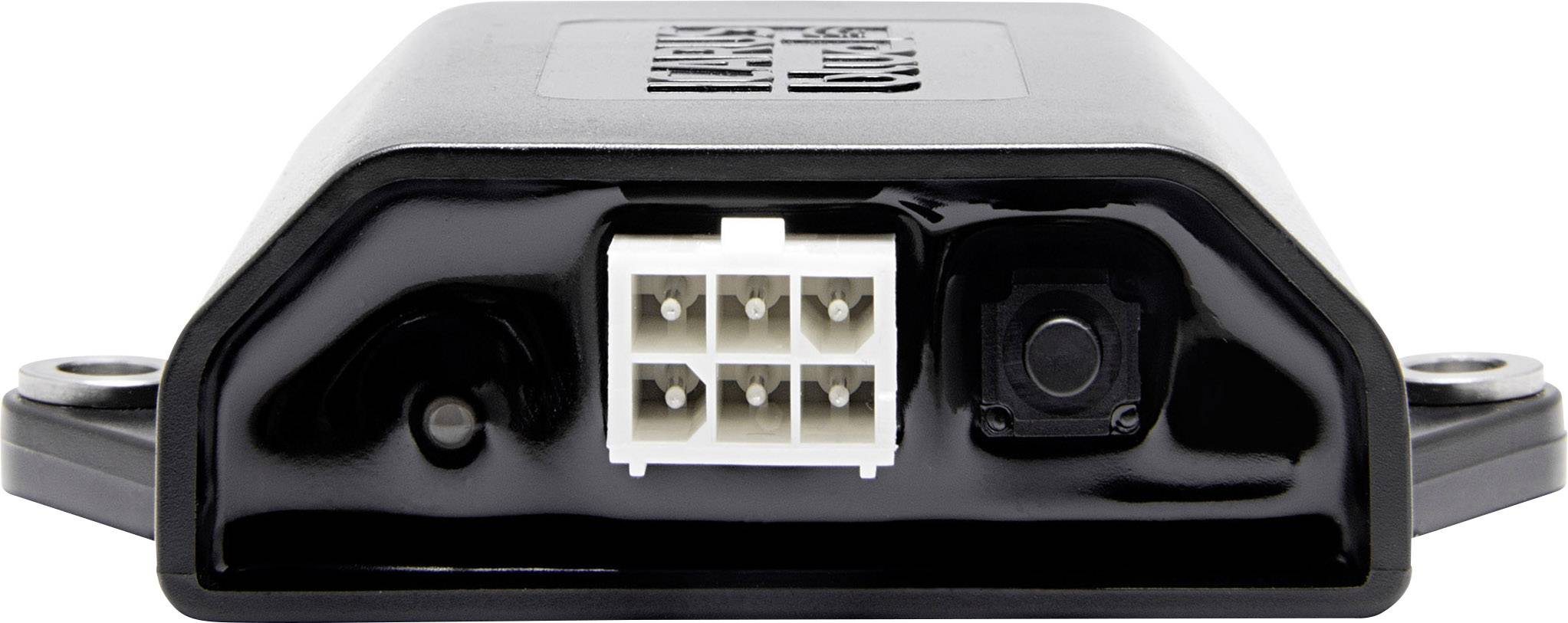 Obdélníkové elektronické zařízení s bílým šestipolohovým konektorem uprostřed, obklopené černým pouzdrem.
