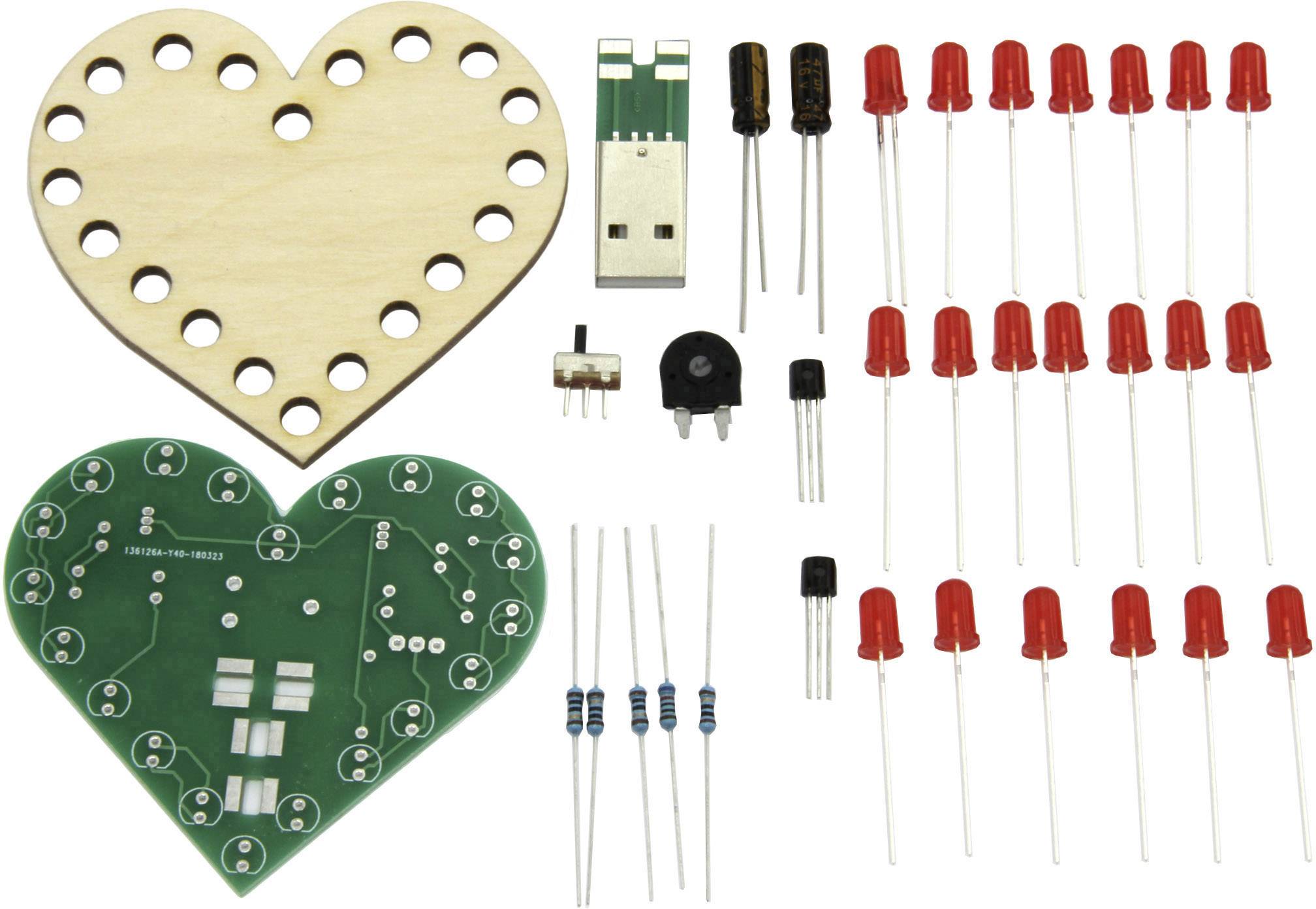 Elektronický stavebnicový set ve tvaru srdce: dřevěný rám, zelená deska plošných spojů, USB konektor, spínač, rezistory, kondenzátory, LED diody.