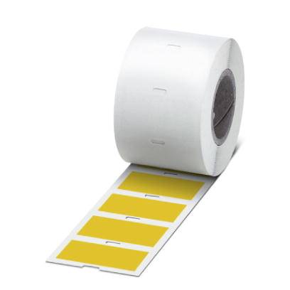 Role se žlutými etiketami, částečně odvinutá, ukazuje čtyři obdélníkové štítky na bílé nosné fólii.