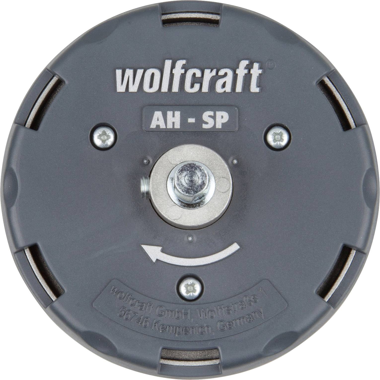 Kulatý šedý adaptér s nápisem 'wolfcraft AH-SP', centrální šroub a šipka. Název výrobce a adresa dole.